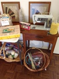 Assorted material, yarn and sewing accessories. Singer machine with cabinet.