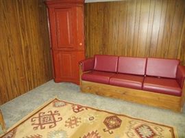 This End Up Leather sleeper sofa. Sofa is 225 lbs and requires professional movers.  Woven rug and corner cabinet are sold.