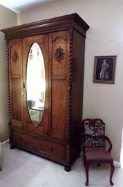 Antique Oak armoire with oval beveled glass mirror
