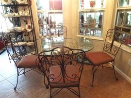 Glass top dinette table and four wrought iron chairs
