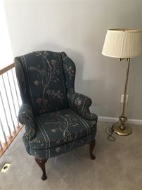 wingback chair and floor brass lamp