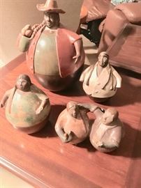 5 round clay figurines