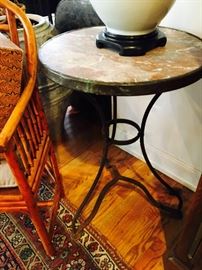 Pair of marble top round tables with aged brass trim and stand
