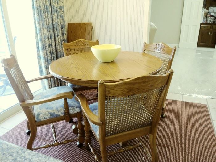 Solid oak table and 4 rolling chairs