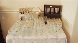 Pretty Gold and Glass Stemware and 2 sets of gold and stainless flatware