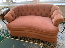 Comfy coral colored plush loveseat