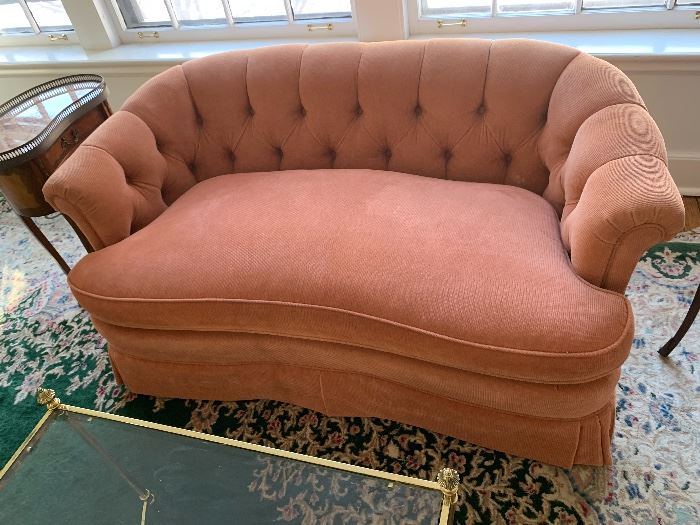 Comfy coral colored plush loveseat