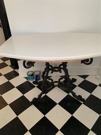Hard surface table with antique wrought iron base