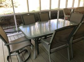 Glass top patio table and 6 chairs, including 2 swivel chairs