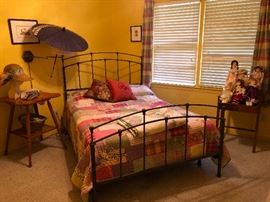 Decorative iron bed. Hand sewn quilts