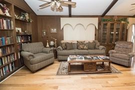 Family Room: Left To Right: Club Chair: $180.00. Octagon Drum Table: $60.00. 3 Cushion Matching Sofa and 6 Throw Pillows: $380.00. Recliner: $30.00 (2 available) Rug (7'4" x 4'8"): $30.00. Oak Veneer Coffee Table. (1'5"h x 4'10"w x 1'10"d): $60.00