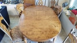 Oval shaped dining table and 6 chairs. Comes with 2 leaves.