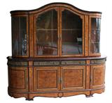 Louis XVI large scale cabinet in burl walnut with curved sides and decorative ormolu detailing.