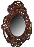 Heavily carved mahogany mirror with babies.