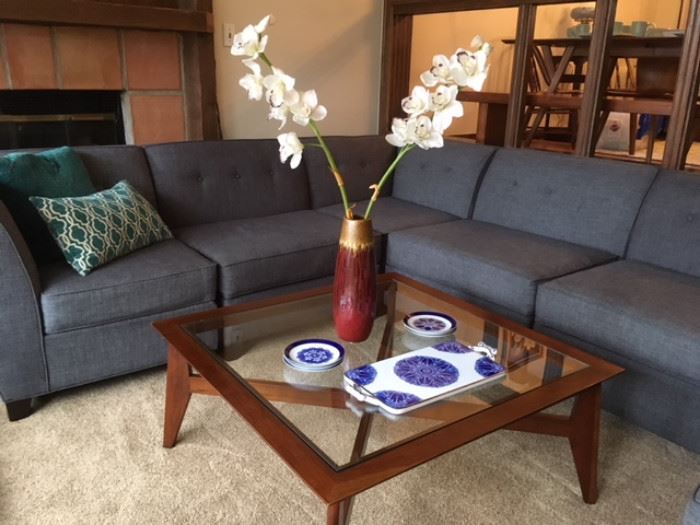 Modern sectional in gray fabric, modern glass top coffee table