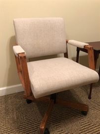 Mid century upholstered chair with wooden accents.