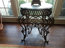 Love all the vintage wrought iron and marble side tables in this house!