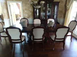 Wonderful Bernhardt "La Scala" double pedestal dining table, measures 46"W, 30"H, 76-112"L, includes 2-18" leaves + felt pads, 8 chairs (2 arm, 6 side) and matching lighted china cabinet.
