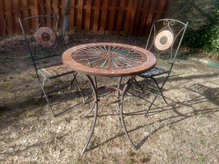 Nice little wrought iron table and two chairs for neighborhood gossip and tete a tete's.