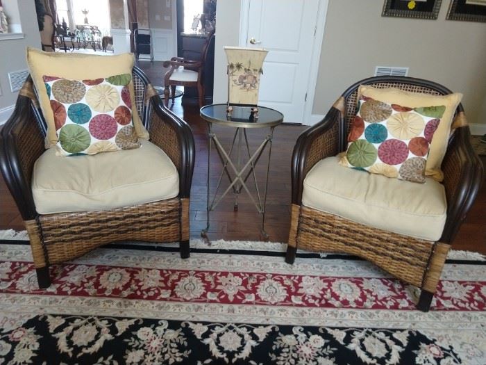 Pair of rattan armchairs, with vintage bronze/black marble side table. 