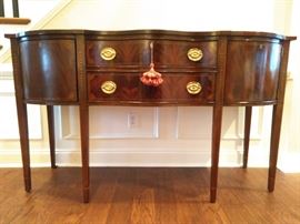 Exquisite Councill Craftsmen Hepplewhite flame mahogany sideboard, with pencil inlay, shell detail in corners of cabinet doors/drawers and cascading bellflower detail on saber legs.