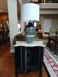 One of a pair of 3-drawer serpentine front chests, with travertine tops. Pair of Surya  black lacquer & MOP inlay table lamps with new shades and matching finials.
