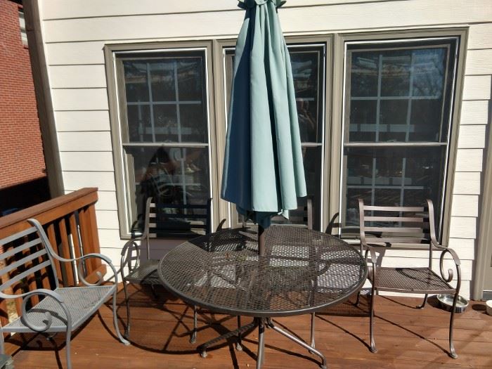 Spring really IS right around the corner and what better way to usher in this pleasant season, than with a round, wrought iron table, 4 chairs and umbrella. Buy your own citronella, you're going to need it!