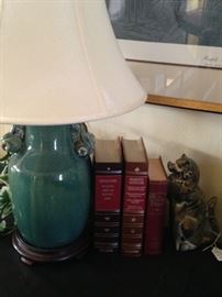 Leather bound books; table lamp