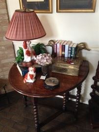 Antique drop leaf barley twist table; Staffordshire dog lamp; brass duckhead bookends