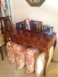 Burled wood desk; decorative pillows