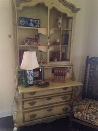 This large French style secretary provides display area, desk space, and drawer storage.