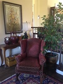 Very comfortable upholstered wingback chair; one of the many live plants