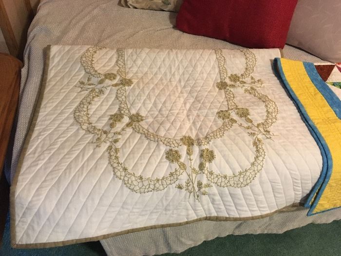Variety of handmade Quilts with intricate needlework.