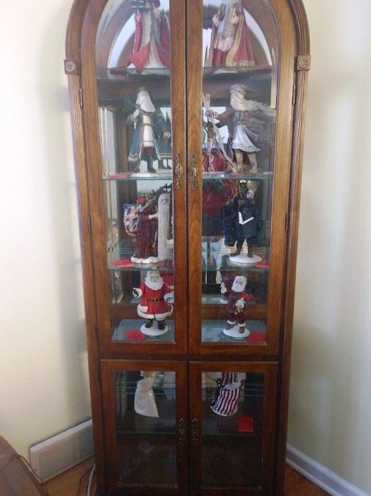 Curio Cabinet with  Duncan Royale Santa Claus collection from 1983.   