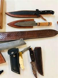 Gorgeous fire forged knives and some have handmade sheaths .