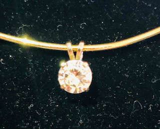 The exquisite Round Brilliant cut Solitaire pendant mounted in 14k Gold was purchased decades ago by a 92 yr old and bequeathed to an heir to help with college education. 
It is a substantial size and measures approximately 1  3/8 carat .  It can most definitely be remounted into a ring or worn as a pendant. It has been tested and measured and guaranteed to be genuine. 




