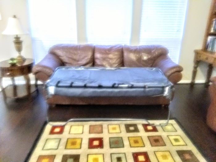 Matching leather sofa converts to "Sleeper Sofa."
