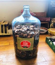 Huge glass water jug full of pennies!