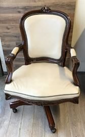 Unique vintage French bergere ladies swivel desk chair upholstered in an ecru colored faux ostrich leather with a quilted back, olive green leather welt trim and antique bronze nailhead trim. The Springtime themed damask fabric features a cabbage, a bunny, a frog on a lily pad, a bushel of asparagus and some sugar snap peas. Dark wood frame is intentionally distressed and has been recently retouched bringing out a beautiful luster in the wood. Typical floral carved design on the top crest of the splat, corners and apron of the seat. The base has four splayed legs with brass capped rolling wheels that show a patina consistent with the age of the piece, yet roll smoothly. Exact age and manufacturer unknown. This chair sits very comfortably with great back support and has a nice soft, yet firm cushion that makes it functional as an actual work chair, as well as an aesthetic delight!

Dimensions: 25”w x 30”d x 35”h • Seat=20”d x 16.5”h • Arm=24.75”h (37lbs)

Condition: In excellent conditi