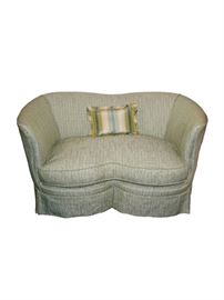  Darling curve shaped loveseat or settee, custom upholstered in a woven silk cotton-blend fabric in an off-white, teal, olive and avocado green color scheme with a dressmaker’s skirt featuring corner pleats. Single welt trim throughout. Single seat cushion filled with polyurethane latex foam and wrapped in 90% duck feather and 10% down with a zipper for easy removal for cleaning. Hooks keep cushion secure on the sofa. Wonderful size and soft curved shape makes it ideal for a bedroom, small living space or even a home office!
Dimensions: 52”l x 24”d x 29”h • Seat=21”d x 17”h • Arm=28”h (80lbs)
Condition: In perfect condition  
