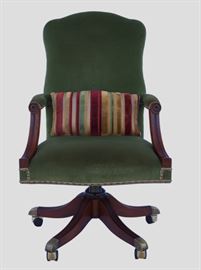 Arthur Brett Mahogany Desk Chair                         Details: Traditional yet regal, Arthur Brett mahogany swivel tilt secretarial chair with a tall back for improved comfort, mounted on a five splay carved pedestal featuring subtle carved detail on the arms and legs. Upholstered in Lichen crush and stain resistant luxury velvet by Beacon Hill from the Netherlands. Finished edges are done in a sand, lichen and burgundy gimp with burnished brass nailhead trim. The custom velvet stripe lumbar pillow is done in GP&J Baker fabric called Figaro Stripe has a zipper for easy removal and cleaning. Marvelously handsome and comfortable chair for any office!
Dimensions: 25.5”w (overall in front) x 28”d x 44.5”h • Seat=19”d x 19”h • Pillow=22”l x 14”w
Note about manufacturer: Throughout the long history of the company, Arthur Brett's craftsmen ship have led fine furniture manufacturing in standards of design and construction. Arthur Brett furniture is acclaimed worldwide as setting the highest