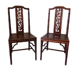 Pair of Chinese Huanghuali Detailed Chairs            Details: A set of two matching huanghuali wood chairs. Made out of prized Chinese Huanghuali wood (Golden Phoebe) and beautifully carved and shaped to mimics stalks of bamboo. Back of chair features a carved panel of carved bamboo.
Dimensions: 17.75”w x 16.5”d x 37”h • Seat=17”h (16lbs each)

Condition: One of the chairs has a scratch on the seat that can be easily covered with a cushion. Slight paint scuff on one leg that can be removed carefully. One chair is slightly darker than the other.
