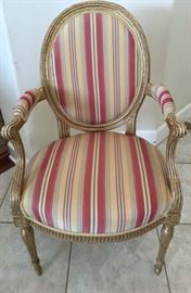 Pair of George III Upholstered  Gilt Wood Open Armchairs                                                                                               B-26/E-93
A fine pair of George III upholstered gilt wood open armchairs with oval backs having decorated
frames embellished with moulded and cared motifs echoed in the stop-fluted downswept arms.
The fluted frieze and turned tapering front legs are also embellished with stop-fluting.

English, circa 1775
Height:35 inches (89 cms)
Width: 22 inches (56 cms)
Depth: 23 inches (59 cms)

Note: *Fabric: New Silk Stripe
          *Trim: Gold Gimp
          *Original Stuffing
The neoclassical design of the chair and the squared outline of the base of the downswept arms is very similar to the work of Thomas Chippendale.
