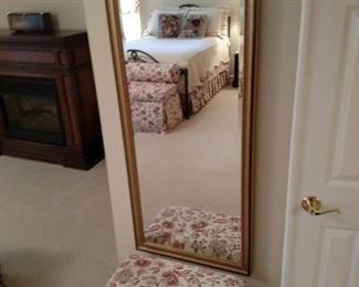 Metal upholstered bench and floor length wall mirror