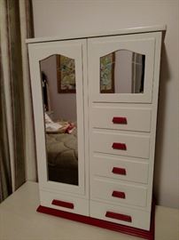 Mary Poppins wardrobe includes High Tea,  Rooftops of London, Nursery Nanny,  Blue coat with scarf,  Gray suit all with stockings and shoes inside this wooden wardrobe