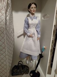 Close up of Mary Poppins doll with hat, umbrella and satchel