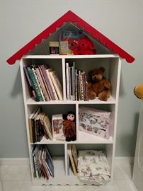 Story book bookcase with story books, stuffed animals and a child's teaset