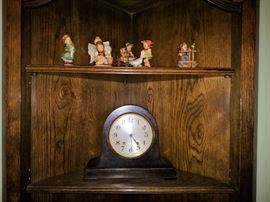 John M. Robert & Sons Co. clock and Hummel figurines
