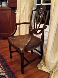 Eight antique mahogany mid 1800's English Hepplewhite shield-back with Prince of Wales feather motif design. Two armchairs,  six side chairs, original leather seats.