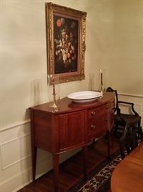 Oil painting of roses and a beautiful cherry sideboard built by a Nashville furniture maker